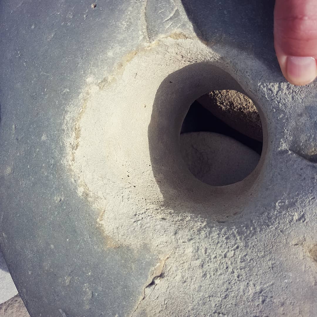 I found another suspicious rock with a hole in it. This one seems to have been worked, the hole is much rougher than the rest of the stone. Swipe for a more modern artifact 😁

Let me know if you think it could have been an weight or anchor!

        